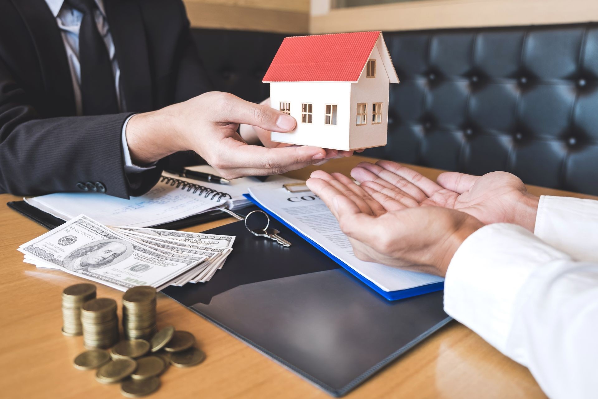 Estate agent sending house model to client after signing agreement contract real estate with approved mortgage application form, concerning mortgage loan offer for and house insurance.